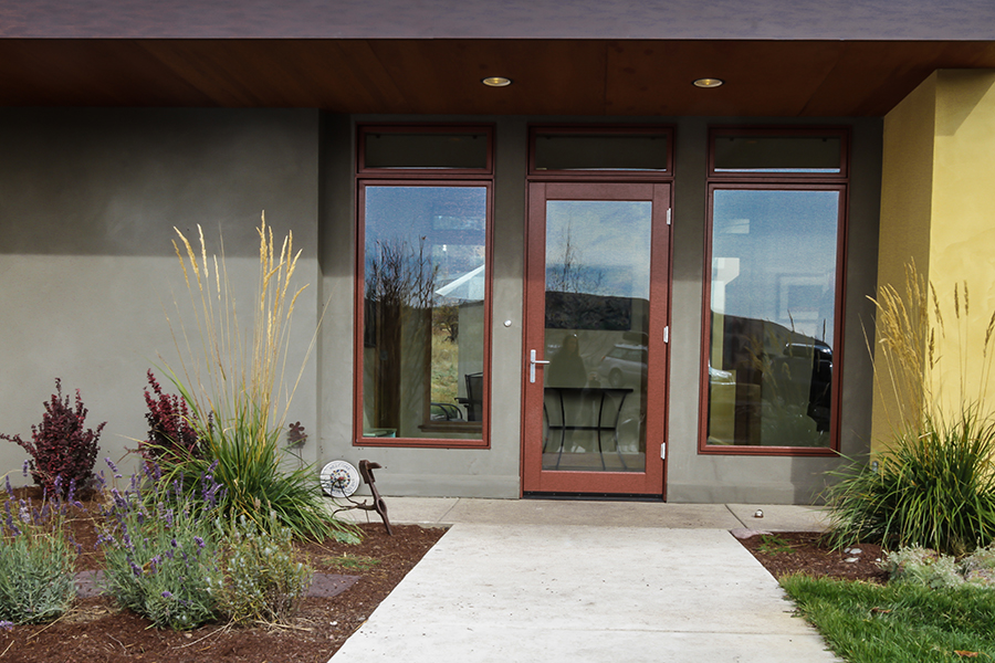 A zoomed in shot of the door, bordered by two large see-through windows, shows a zero-step entry and convenient lever-style door handle.